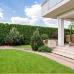 porch with dining table with yard surrounding