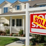 home with "sold" sign out front