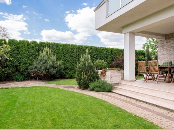 porch with dining table with yard surrounding