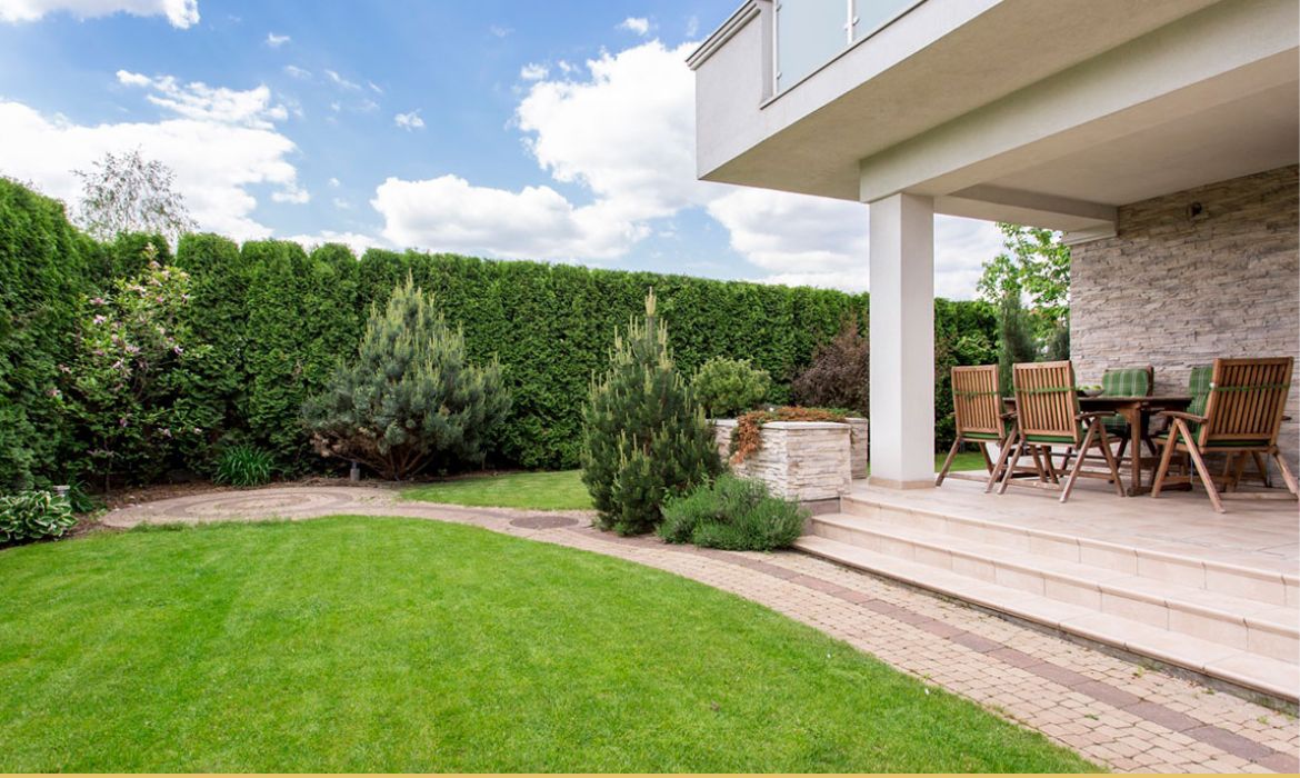 porch with dining table with yard surrounding