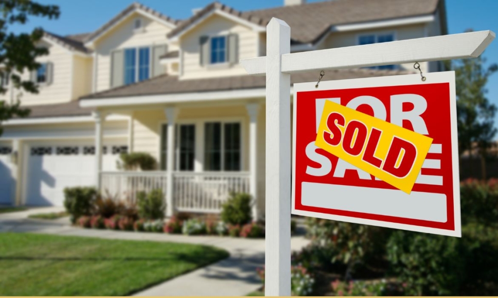 home with "sold" sign out front