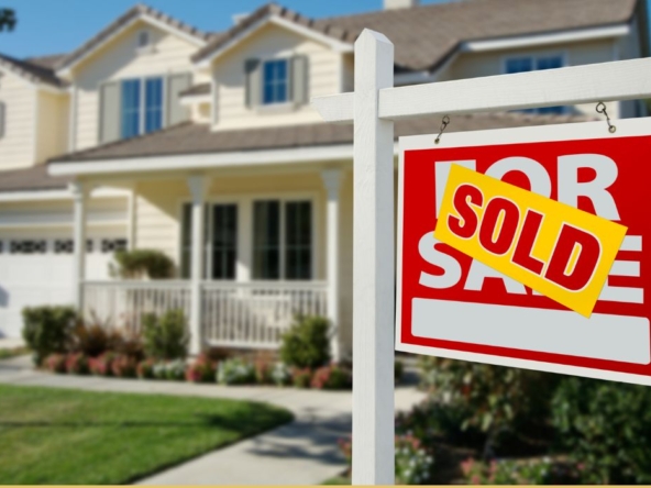 home with "sold" sign out front