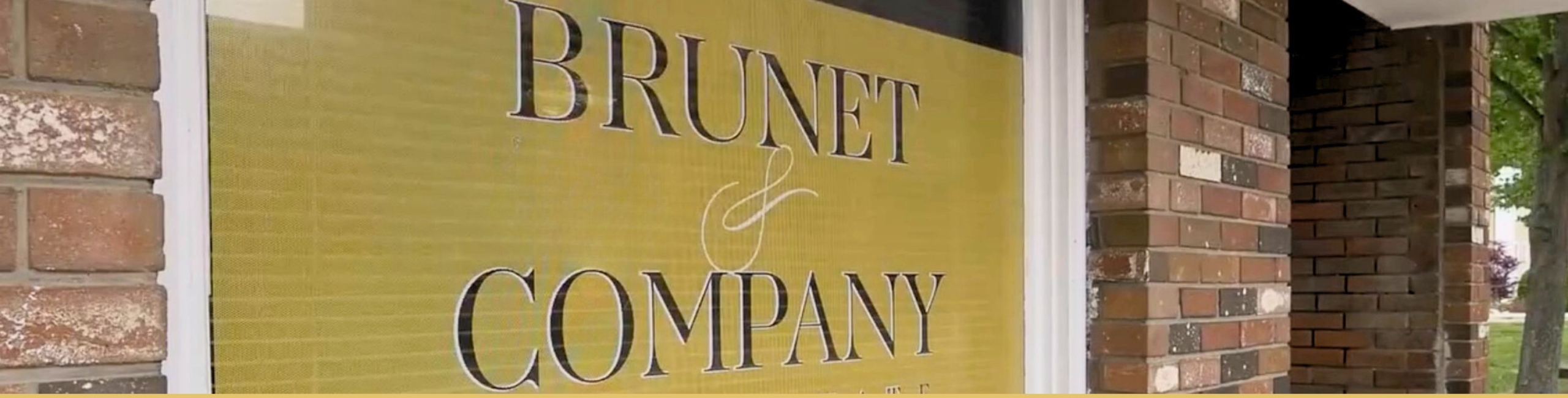 Brunet & Company Real Estate window sign